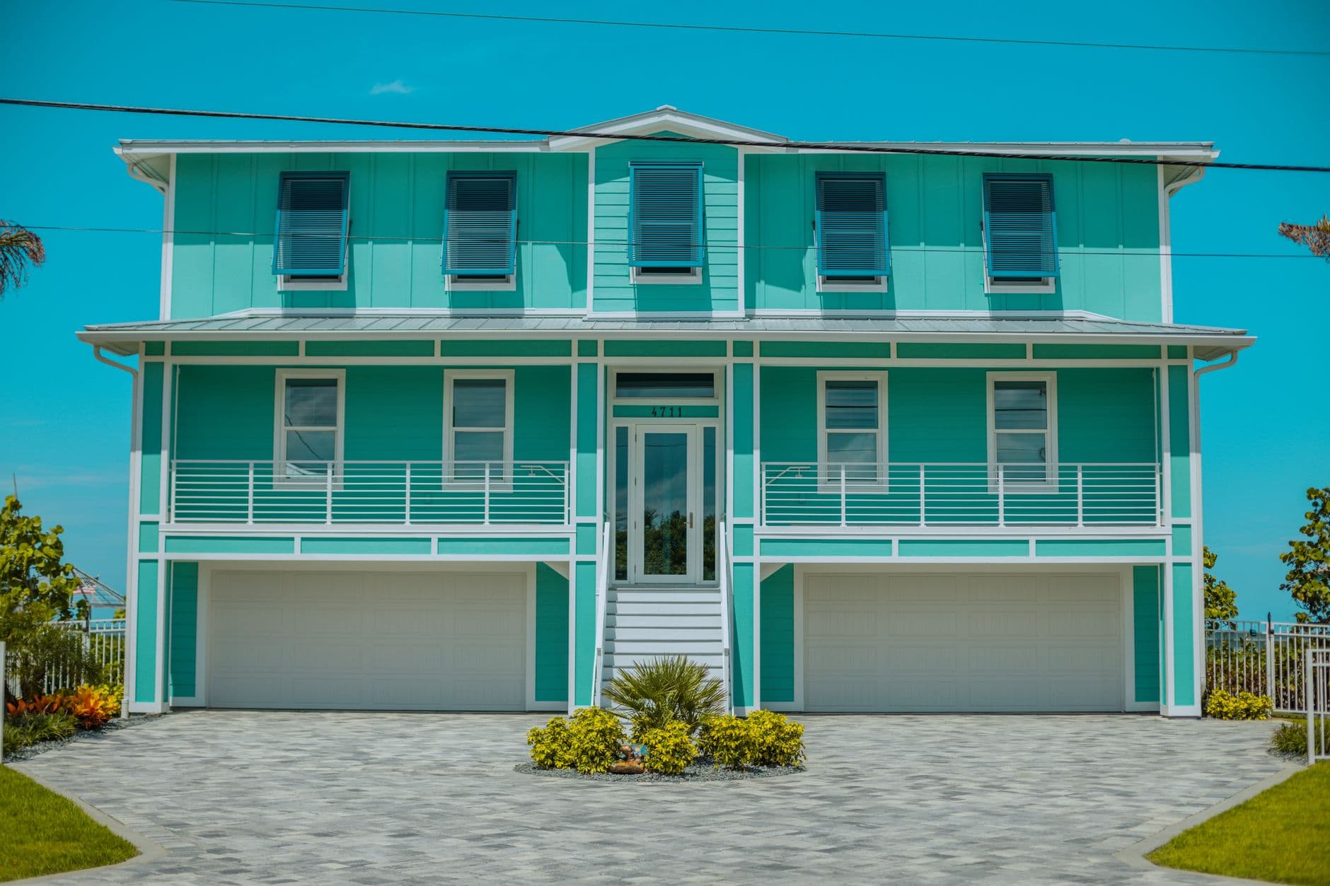 A modern teal beach house with a spacious design in Daytona Beach, Florida.