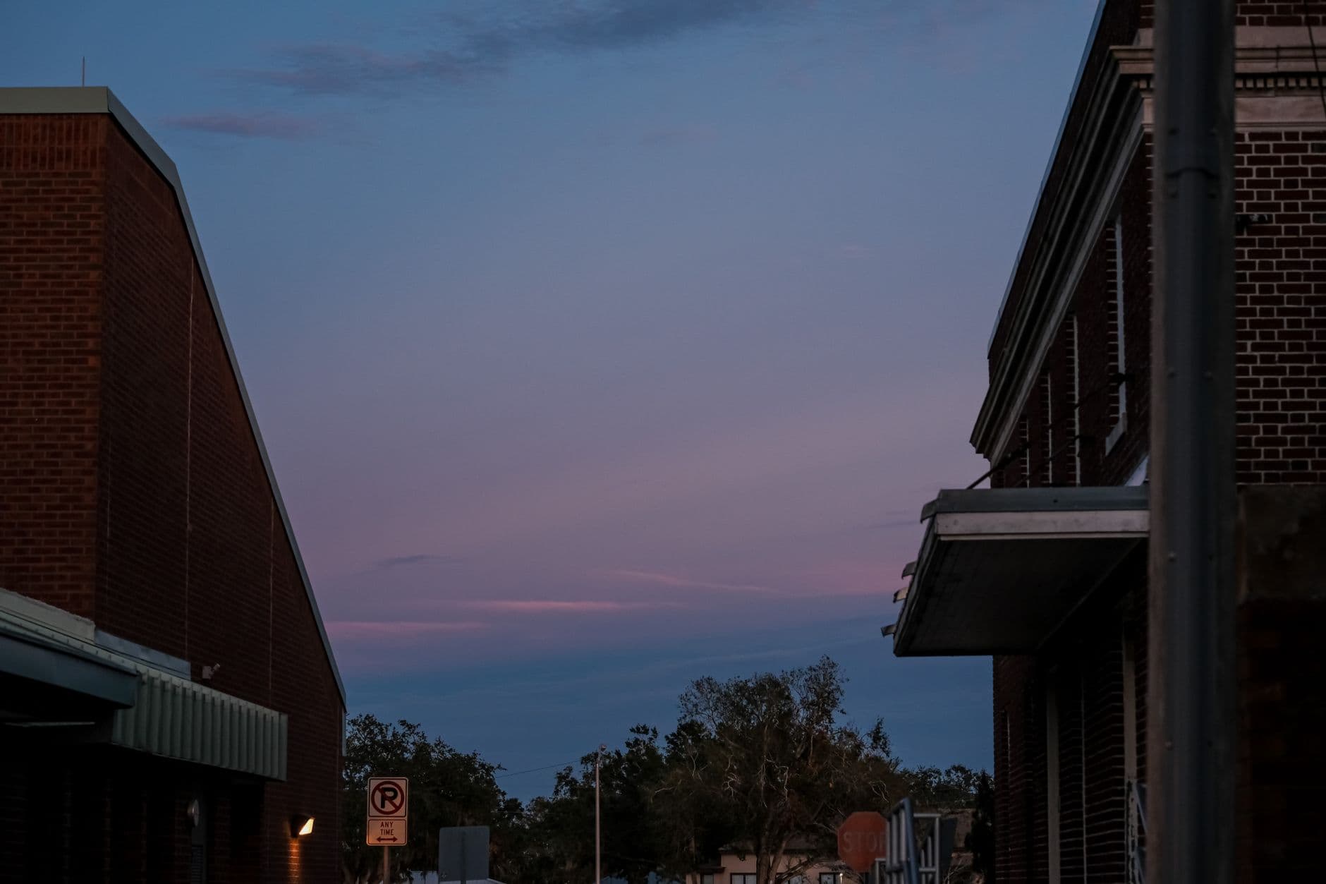 Urban landscape with brick buildings and twilight sky, highlighting architectural design.